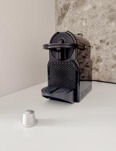 a black toaster sitting on a counter next to a mirror at Apartment Verdi BARDOLINO in Bardolino