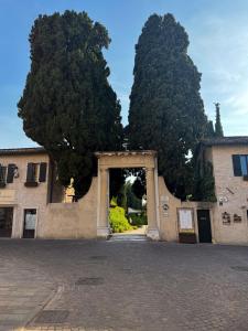 an entrance to a building with two large trees at Apartment Verdi BARDOLINO in Bardolino