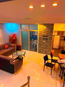 a living room with a couch and a table at شالية الرايس in Rayyis