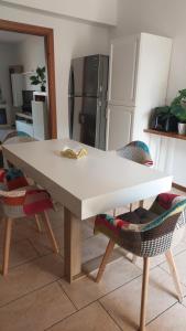 a white table in a kitchen with two chairs at Mar&Mat in Giarre +16 photos