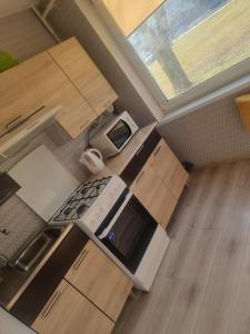 an overhead view of a kitchen with a stove top oven at Cute Flat in Kėdainiai