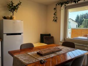 a kitchen with a table and a white refrigerator at Appartement Frieda in Seeboden +13 photos