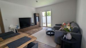 a living room with a couch and a tv at Ferienhaus freiZeit in Rudolstadt