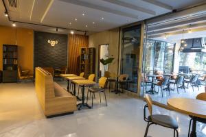 a restaurant with tables and chairs and windows at Royal Capital Thermal & Spa Hotel in Bursa