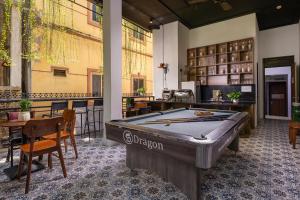 a pool table in the middle of a room at Drift Backpackers Hostel in Hanoi