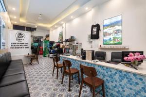 a restaurant with a bar with chairs and tables at Drift Backpackers Hostel in Hanoi