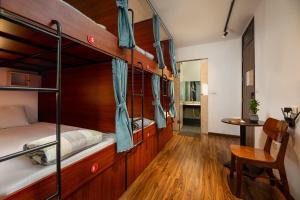 a bedroom with two bunk beds and a desk at Drift Backpackers Hostel in Hanoi +56 photos