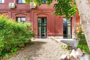 a red brick building with a glass door at Raw Luxury Loft in Vilnius in Vilnius