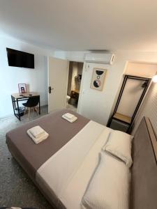 a bedroom with a large bed and a desk at athensdot in Athens