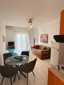 a kitchen and living room with a table and chairs at Athena Kythera in Diakofti