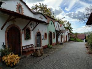 a white building with a bench next to a street at Baťův kanál Babice1 glamping in Babice