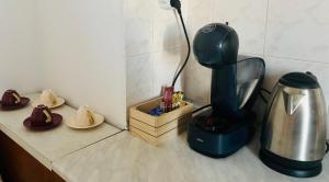 a kitchen counter with a coffee maker and a blender at KA Home in Petrich