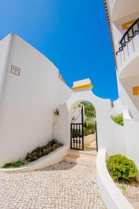 a staircase leading to a door in a white building at Casa Sem Pressa - Beach, Pool & Central Carvoeiro in Carvoeiro +10 photos
