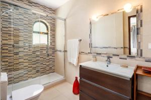 a bathroom with a shower and a sink and a toilet at Casa Sem Pressa - Beach, Pool & Central Carvoeiro in Carvoeiro