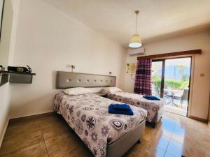 a bedroom with two beds and a balcony at Florence Hotel Apartments in Ayia Napa +84 photos