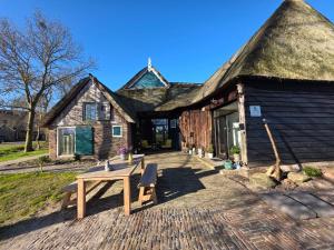 a house with a picnic table in front of it at Bed and Breakfast Reestdal in Meppel
