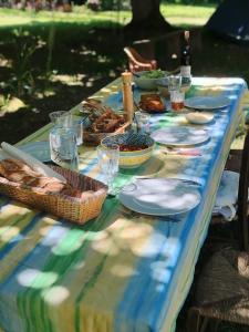 a table with a blue and green table cloth with food at La yourte gasconne in Estampures