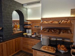 a kitchen with a bunch of bread on a counter at Hotel Garni Bel-Ami in Galtür
