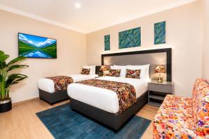 a hotel room with two beds and a couch at Bond Hotel in Istanbul