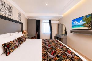 a hotel room with a bed and a flat screen tv at Bond Hotel in Istanbul
