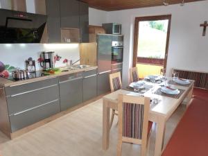 a kitchen with a wooden table and a dining room at Haus Margret in Stummerberg