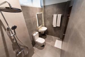 a bathroom with a toilet and a sink at The Embrace Luxury Villa - Hiriketiya in Dickwella
