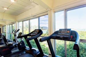 a gym with two elliptical machines and windows at Fair House Villas & Spa, Koh Samui in Mae Nam