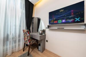 a room with a tv and a desk and a chair at Bond Hotel in Istanbul +40 photos