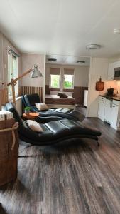 a living room with two large bean bag chairs at Bos & Bubbels Chalet in Epe