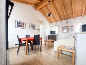 a living room with a red table and chairs at Apartments Colombara Bardolino in Bardolino