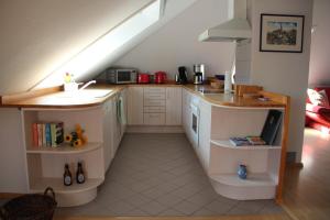 a kitchen with a counter and a sink in a room at Ferienwohnung Max-und-Moritz in Flensburg