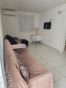 a living room with a couch and a table at Indie little house in Limassol