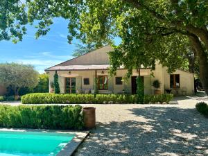 a house with a pool in front of it at La Villa Bohème Piscine Jardin Vue Luberon in Oppède