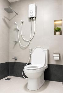 a bathroom with a toilet with a shower at Nature Lounge in Udawalawe +35 photos
