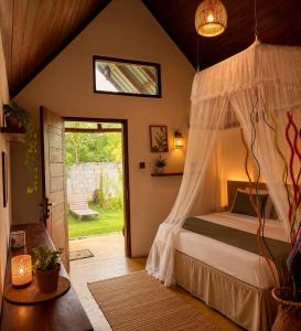 a bedroom with a bed with a canopy at Nature Lounge in Udawalawe
