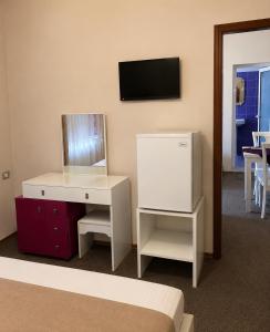a bedroom with a white desk and a mirror at British Hotel in Himare