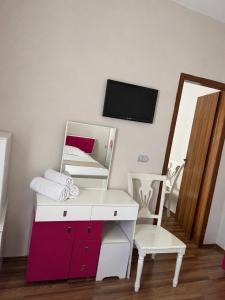 a white desk with a mirror and a chair at British Hotel in Himare +30 photos