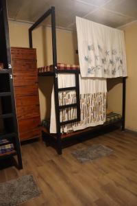 a room with two bunk beds and a dresser at Laughing Leopard Hostel in Nuwara Eliya