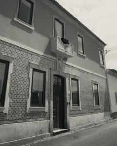 a brick building with a door and a balcony at Casa de St António in Murtosa