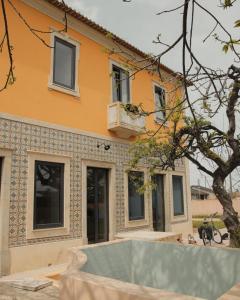 a yellow house with a blue and white tile at Casa de St António in Murtosa +51 photos
