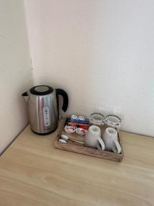 a tray with a coffee pot and cups on a table at Vievija in Vievis