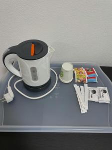 a tray with a tea pot on top of a table at Antico Ticino Malpensa in Lonate Pozzolo