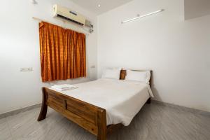 a bedroom with a bed in a room with a window at FM Villa Auroville in Pondicherry +64 photos