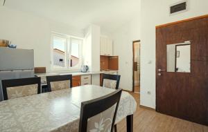 a kitchen with a table and chairs and a door at Apartments Bašić Pirovac - Sea view - Small and large groups in Pirovac