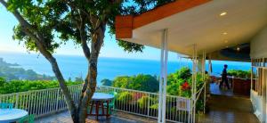 a balcony with a view of the ocean at Arirang Sea View Homestay in Senggigi