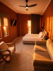 a hotel room with a bed and a couch at Regina Hotel in Kissamos
