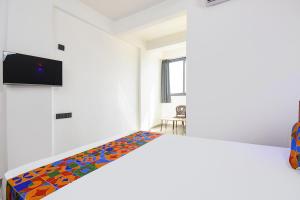 a bedroom with a bed with a colorful patterned mattress at FabHotel DSP in Pune