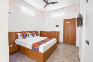 a bedroom with a bed and a television in it at FabHotel DSP in Pune +35 photos