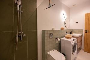 a bathroom with a toilet and a glass shower at Asini deluxe suite 1, with rooftop terrace and breathtaking views in Asíni +51 photos