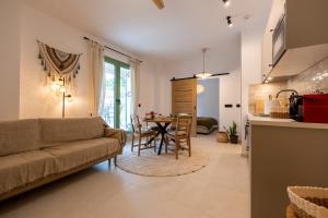 a living room with a couch and a table at Asini deluxe suite 1, with rooftop terrace and breathtaking views in Asíni